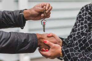 A broker handing house keys to a client.