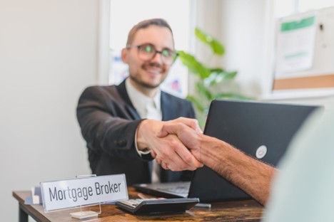 A mortgage broker shaking hands with a client.