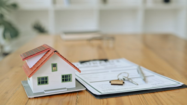 Model house with mortgage papers