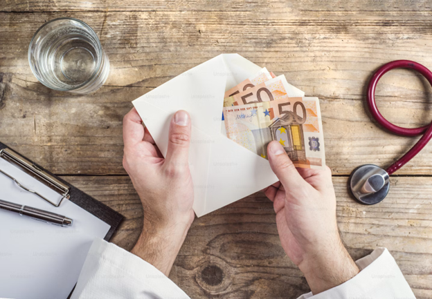 Man holding envelope full of cash