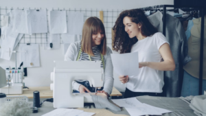 Small business owners working together on paperwork in a storefront.